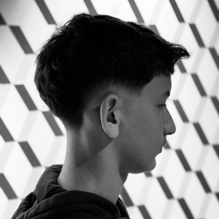 Un low fade parfaitement maîtrisé chez The Barber Company Auxerre : transition douce, contours impeccables et finition millimétrée. Le dégradé idéal pour un style frais et soigné, réalisé par nos barbiers spécialistes à Auxerre.